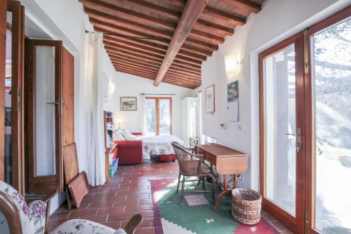 a living room with a table and chairs and a room at Casa Violet - Goelba in Portoferraio