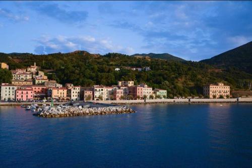 a group of buildings on the shore of a body of water at Appartamento e Mansarda al mare in Rio Marina