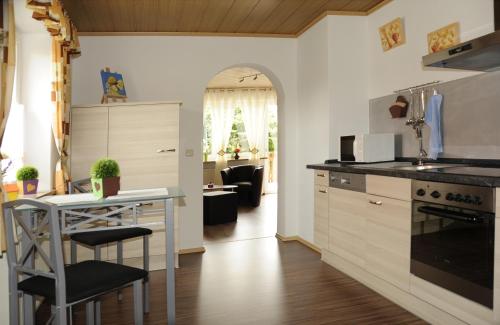 a kitchen with a counter and a table in it at Ferienwohnung "Am alten Main" in Kemmern