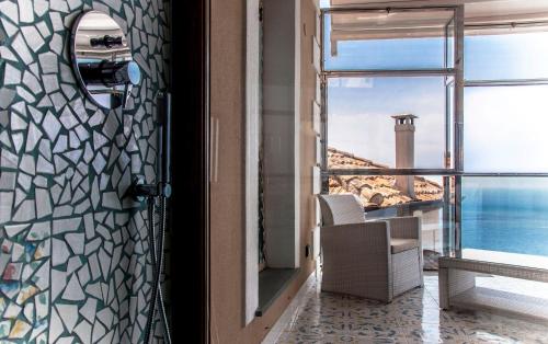 a room with a door with a view of the ocean at Residenza D'epoca Tamara in Castellabate