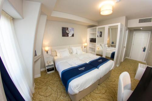 Säng eller sängar i ett rum på Tribeca Hotel