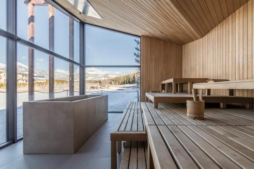 a room with a bench and a large window at Hotel Seehof Nature Retreat in Naz-Sciaves