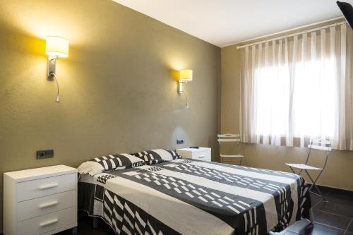 パラフルジェイにあるLes Formigues 3のベッドと窓が備わるホテルルーム