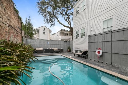 a swimming pool in the backyard of a house at Amazing 3BR Cottage off St Charles with Pool in New Orleans