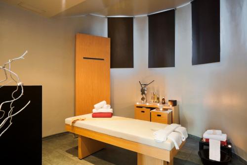 a room with a bed and a wooden cabinet at Senator Banus in Estepona