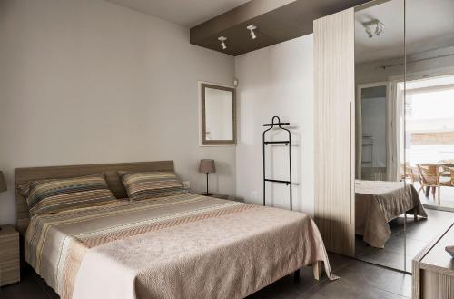 Un dormitorio blanco con una cama grande y una ventana en Casa Vacanza Talia CaseSicule, en Pozzallo