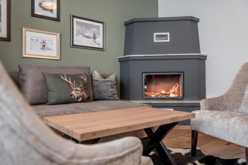 a living room with a couch and a fireplace at Apartmenthaus Enzian Hochsölden in Sölden