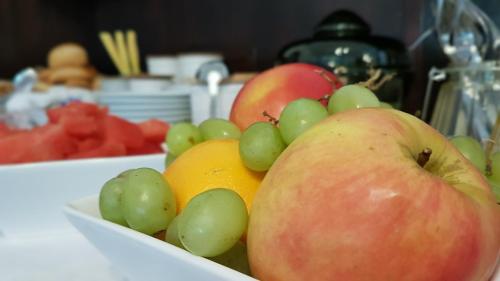 a bowl of fruit with apples oranges and grapes at Olivin Kytlice in Kytlice