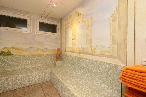 a bathroom with a mural on the wall at Gästehaus Renate in Längenfeld