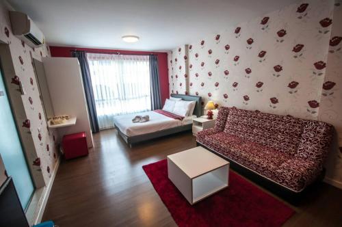 a living room with a bed and a couch at Baan Imm Aim Condo Hua Hin in Hua Hin