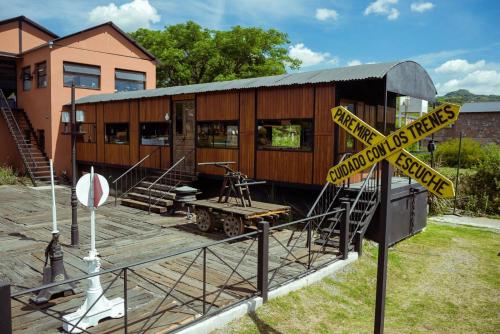 a train station with a caution sign in front of it at Cabañas San Lorenzo in San Lorenzo