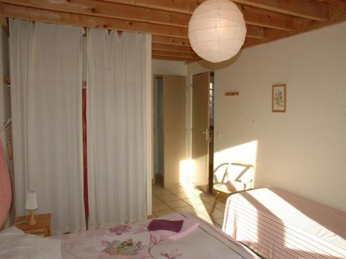 a bedroom with a bed and a lamp at Chalet l'Angélique in Bolquere Pyrenees 2000