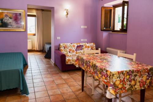 
a room with a table, chairs, and a table cloth at Country House Le Calvie in Camerino
