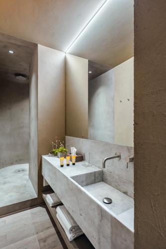 a bathroom with a large sink and a tub at Hotel dei Barbieri in Rome
