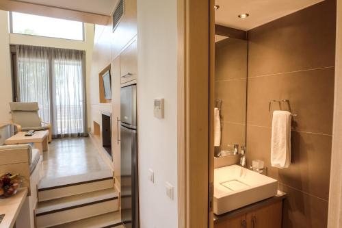 a bathroom with a sink and a mirror at Melimar Homes By The Sea in Marathias