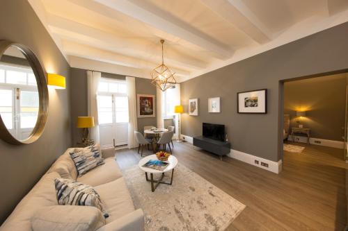 a living room with a couch and a table at Merchants Street Valletta Apartment in Valletta