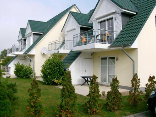 a row of houses with green roofs at Fewo Dat Ole_ZECH in Ostseebad Karlshagen