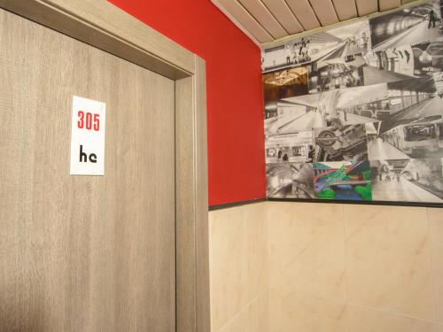 a door in a room with a sign on the wall at Hotel Elba in Rimini