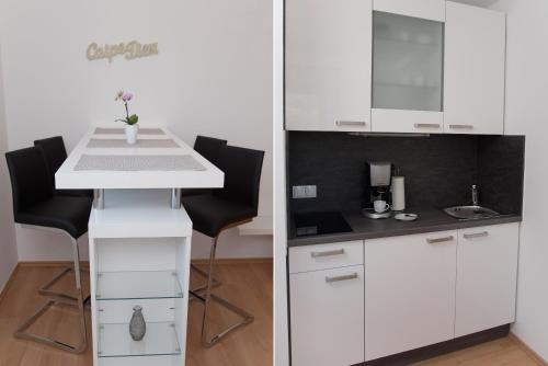 a kitchen with white cabinets and a white counter top at Das Eberhart in Köflach