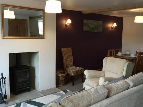 a living room with a couch and a fireplace at Black Swan Inn in Masham