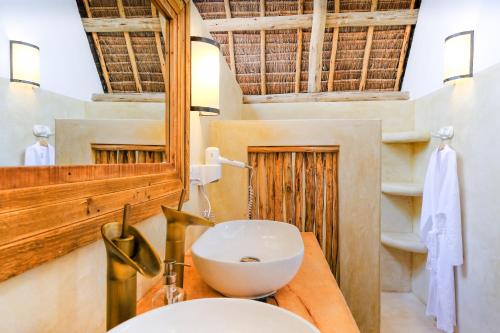 a bathroom with a sink and a toilet at Baladin Zanzibar Beach Hotel in Michamvi