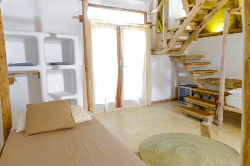 a room with a loft bed and a couch at Baladin Zanzibar Beach Hotel in Michamvi