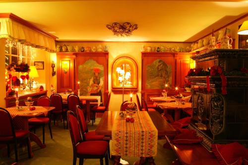 a restaurant with tables and chairs in a room at Hotel Behringer's Traube in Badenweiler
