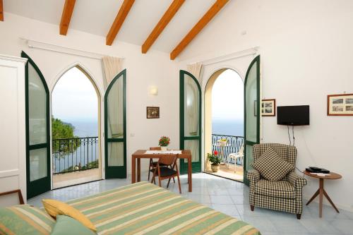 a bedroom with a bed and a table and chairs at La Dolce Vita Ravello in Ravello