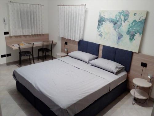 a bedroom with a large bed and a table at Salvia e Timo Rooms in Borso del Grappa