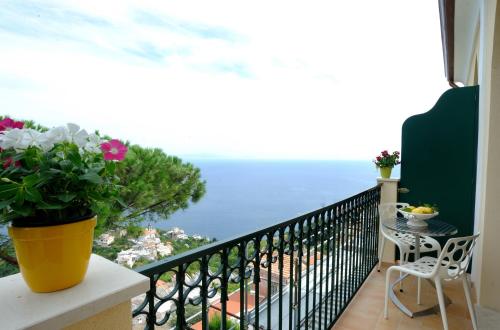 a balcony with a view of the ocean at La Dolce Vita Ravello in Ravello