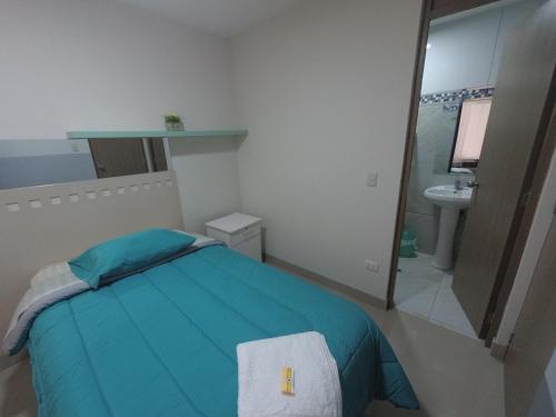 a bedroom with a bed and a sink and a mirror at Fragata Camaná in Camaná