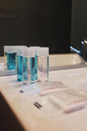 two bottles of water sitting on a bathroom sink at Lost Apartments in Porto