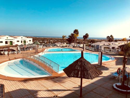 una gran piscina con sombrilla en un complejo en Vista Dorada 7A, en Maspalomas