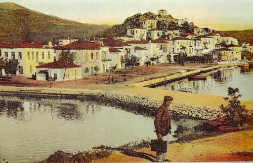 a painting of a person standing next to a body of water at Hellen Studios in Megali Ammos