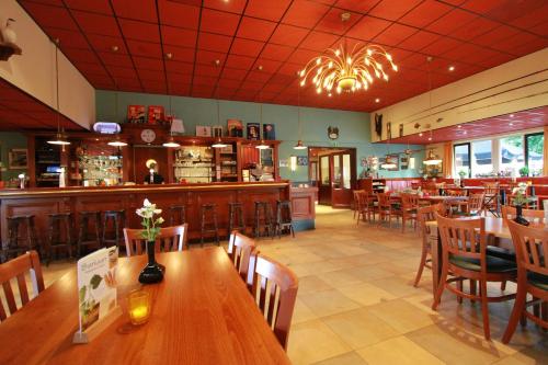 a restaurant with tables and chairs and a bar at The Beach-house nr.98 in Molkwerum