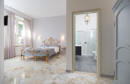 a bedroom with a bed and a bathroom with a mirror at L'ANGOLO DI OLI' in Lecce