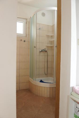 a shower with a glass door in a bathroom at Apartments Lončar in Gradac