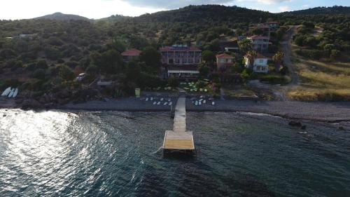 a dock in the middle of a body of water at Limonata Hotel Assos in Behramkale