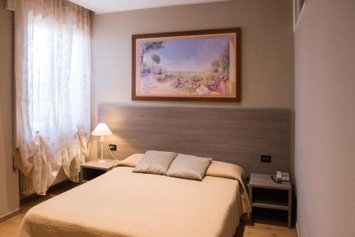 A bed or beds in a room at Albergo Grappolo D'oro