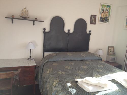 a bedroom with a bed with two towels on it at Al Sandalyon in Quartu SantʼElena