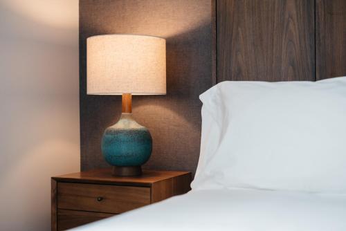 a lamp on a night stand next to a bed at Park City Peaks in Park City