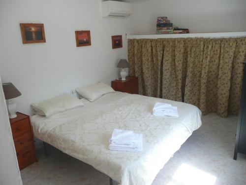 - une chambre avec un lit et 2 serviettes dans l'établissement Finca de la Fuente, à Coín