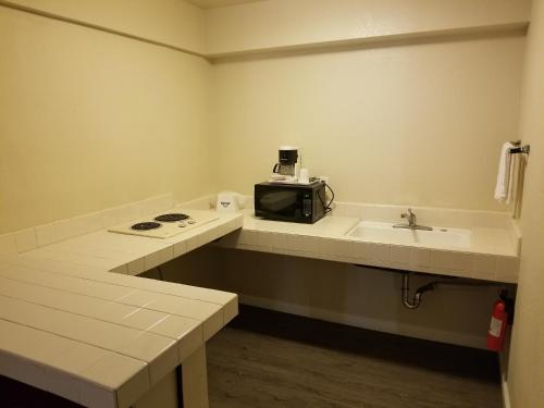 A kitchen or kitchenette at Mission Inn and Suites