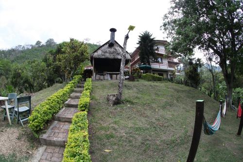 a house on top of a hill with a garden at HOTEL LA SELVA Reserva in La Vega
