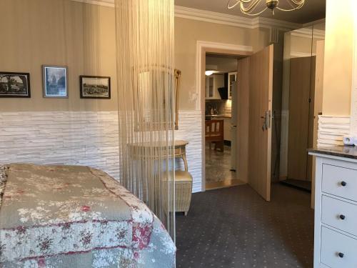 a bedroom with a bed and a table and a mirror at Kwaterka in Brenna