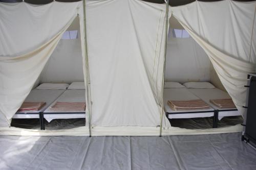 Postel nebo postele na pokoji v ubytování Camping Village Canapai