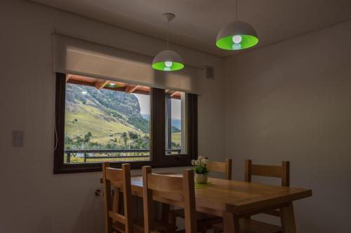 a dining room with a table and a window at Andino Aparts - El Chaltén in El Chalten