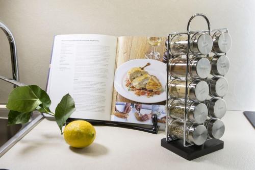 an open book on a table with a plate of food at Borgo Argiano in Castelnuovo Berardenga