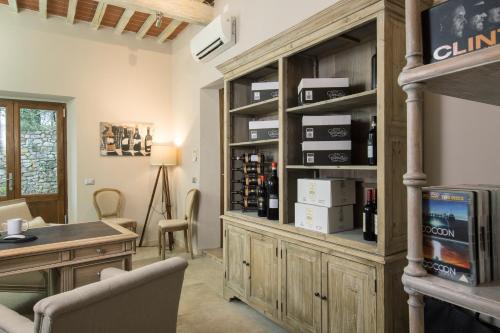a wine tasting room with a large wooden cabinet at Borgo Argiano in Castelnuovo Berardenga