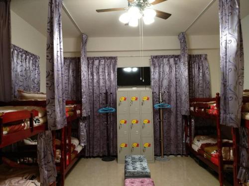 a bedroom with two bunk beds and a television at 988 Ancient House B&B in Jincheng